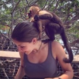 woman with small monkey on her shoulder